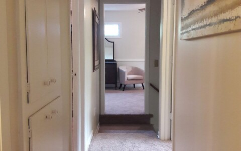 Paint the woodwork to lighten a hallway.