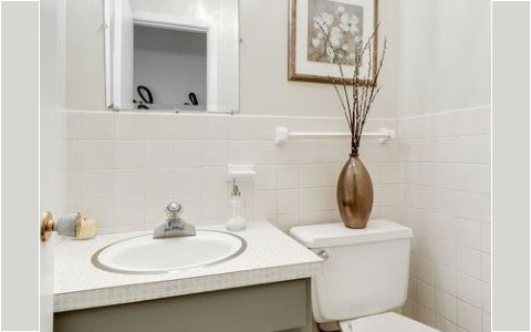 Removing dated wallpaper and a fresh coat of paint on the walls and cabinet was just enough to not draw attention to the dated countertop.