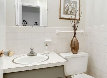 Removing dated wallpaper and a fresh coat of paint on the walls and cabinet was just enough to not draw attention to the dated countertop.
