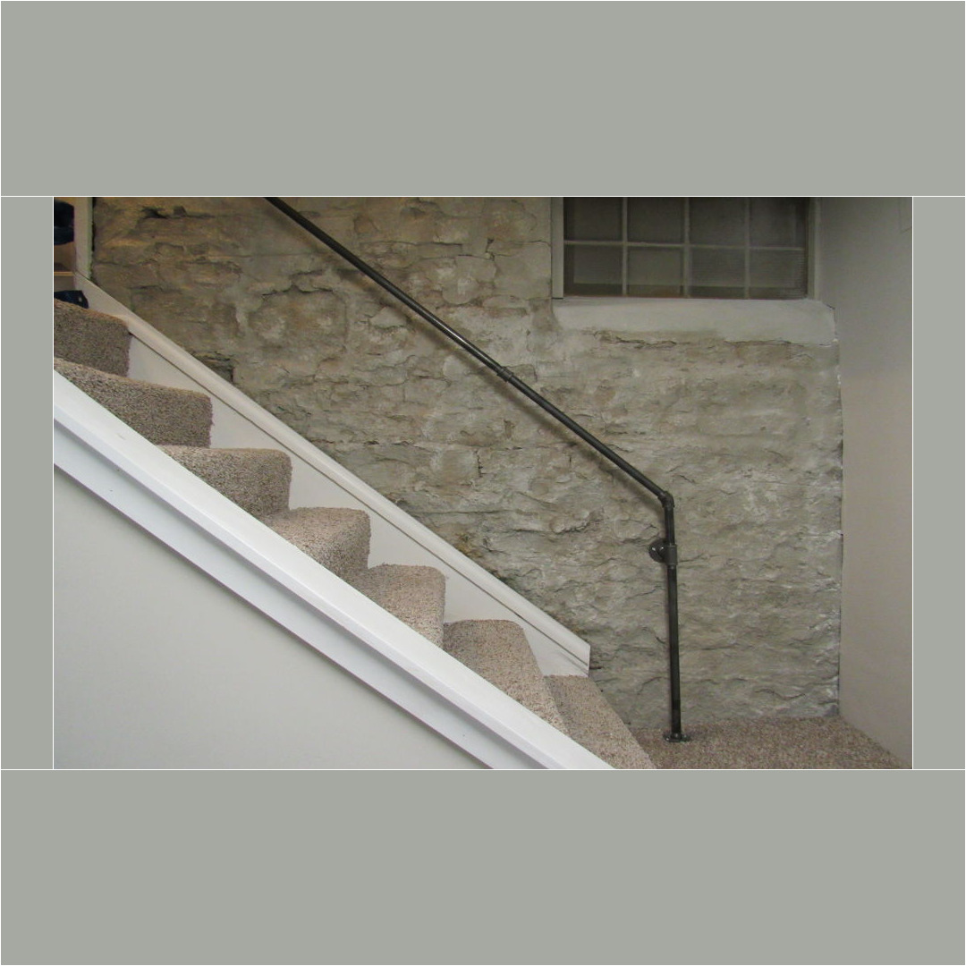 Finish the unfinished wall, faux painted the limestone wall and added industrial handrail.