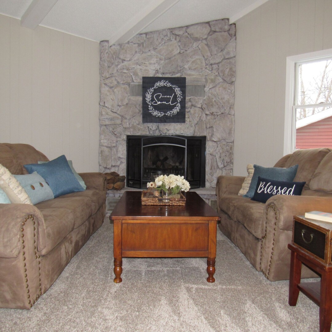 Faux painting the fireplace stone and paneling updates the space and makes a dramatic difference.