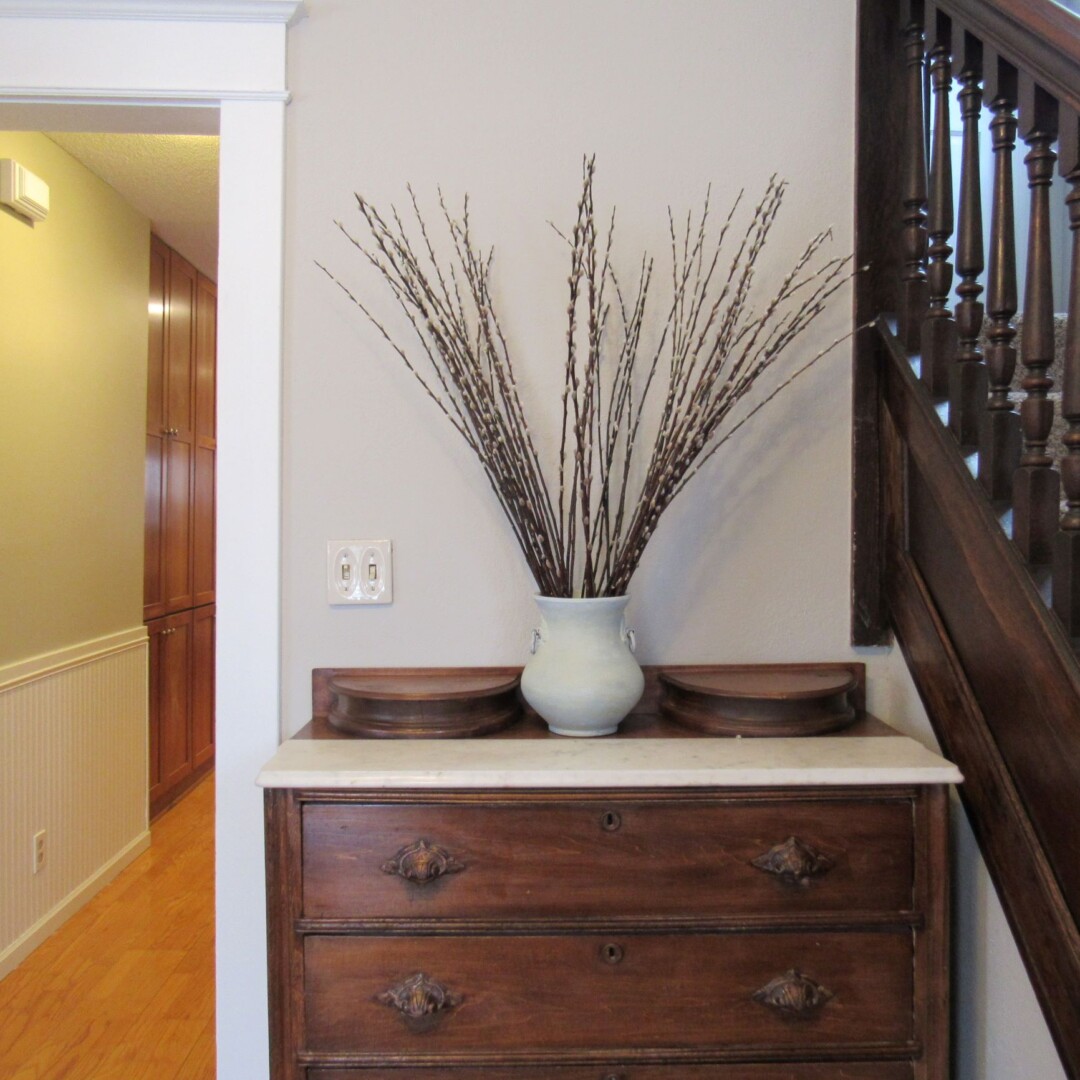Removing worn and faded wallpaper and painting the front entry gives a welcoming and different first impression.