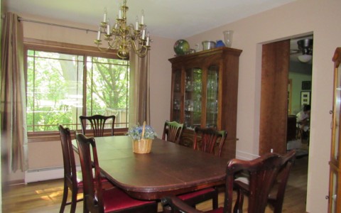 Large china cabinets on both sides of the dining room made the room appear much narrower.