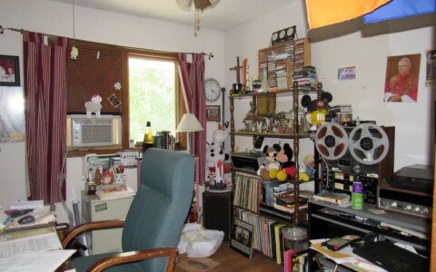 Office space cluttered with personal belongings.